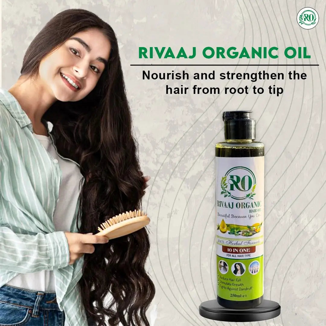 Woman with long hair holding a brush next to a bottle of Rivaaj Organic Oil on a light background